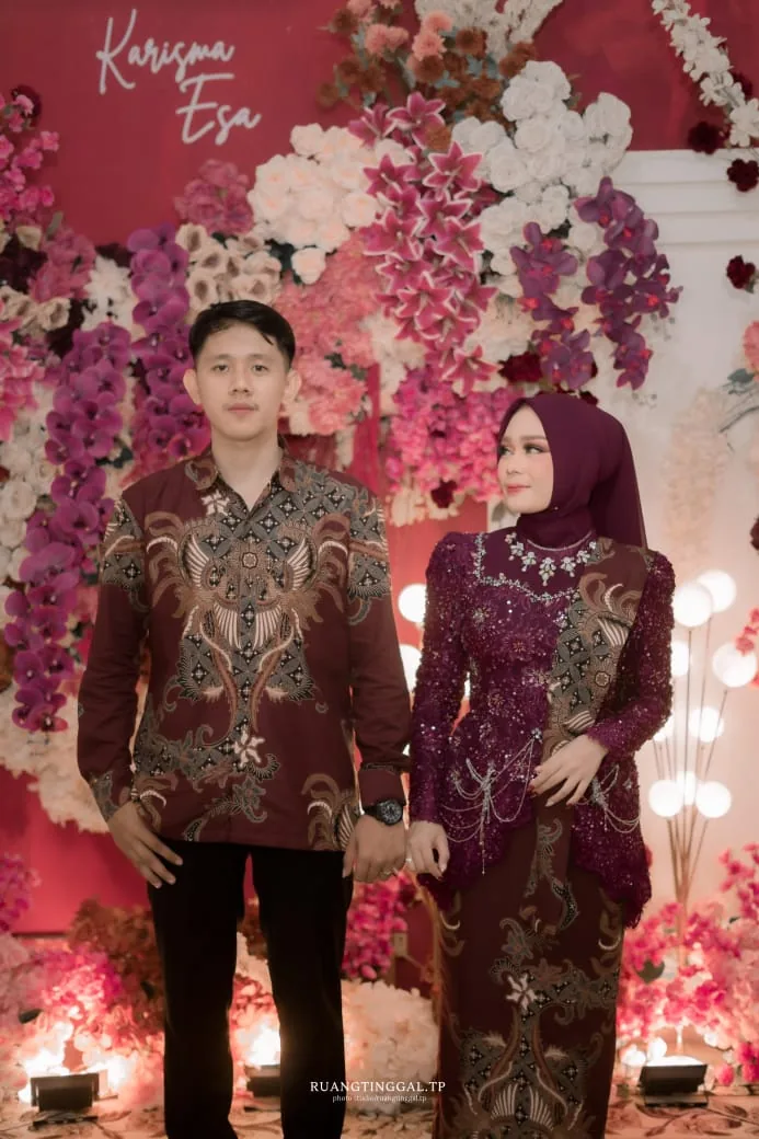 Sepasang pengantin mengenakan batik couple bermotif senada